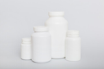 supplement pills with medicine bottle health care and medical top view. Vitamin tablets. Top view mockup bottle for pills and vitamins with green leaves, natural organic bio supplement, copy space