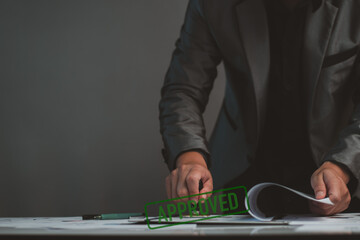Business approved concept. Manager hand stamping with approved stamp on certificate document public paper, investment certificate, business document, certificate approved, investment allowed.
