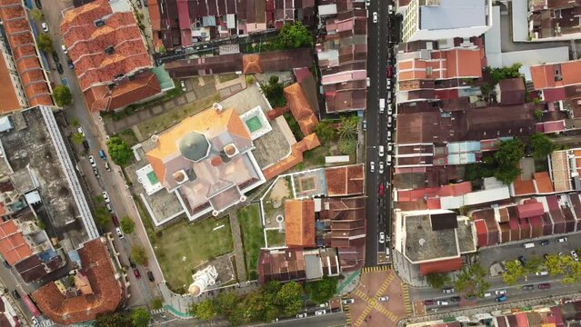George Town, Malaysia: Aerial top down drone footage of the historic George Town UNESCO city center with the Kapitan Keling Mosque in Penang island. Shot with an upward and rotation motion