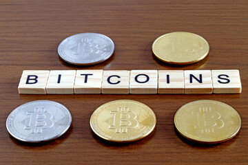 Set of bitcoin or cryptocurrency coins on a wooden table