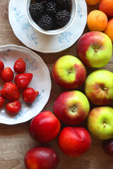 Various healthy seasonal food arranged on wooden background. Flat lay.