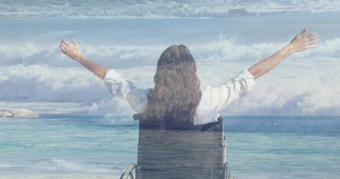 Animation of sea landscape over disabled biracial woman sitting in wheelchair
