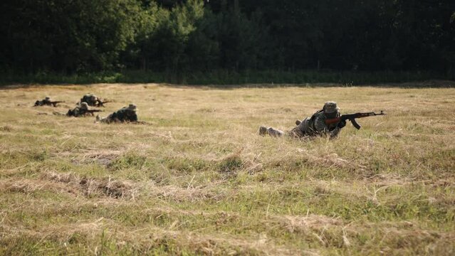 In the battlefield, a group of soldiers with weapons and ammunition is attacking the enemy, the Military Special Forces Unit
