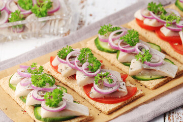 Sandwiches with herring and vegetables