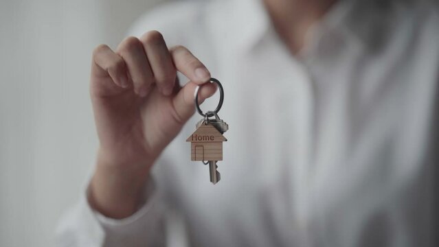 Real estate brokerage agent Hand over the sample house and key Offered for sale, home insurance concept agreement. Making lease and buying a house.