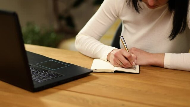 Woman hand making notes in notepad, female hands writing down