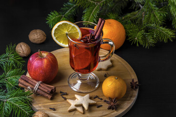 Christmas mulled wine and tangerines on a wooden background.