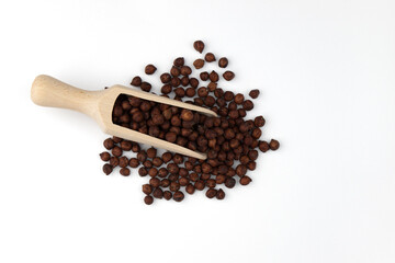 wooden scoop of raw wooden scoop of raw chickpeas on white background, top view