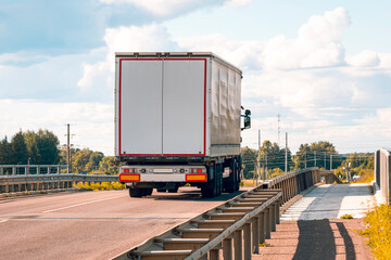 White truck on asphalt road ground with metal safety barrier