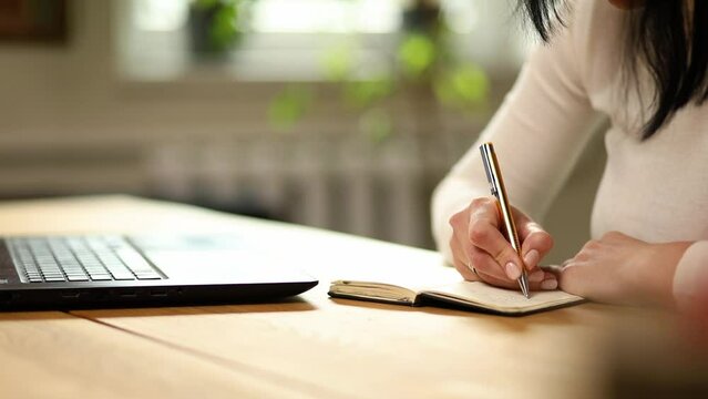 Woman hand making notes in notepad, businesswoman freelancer