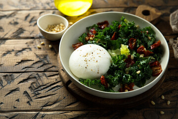 Healthy kale salad with fresh cheese and pine nuts