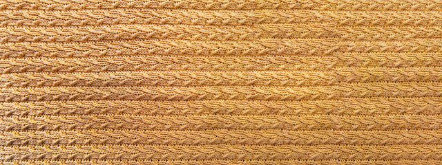 autumn background with colored leaves on a knitted texture