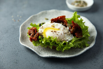 Poached egg on toast with sun dried tomatoes