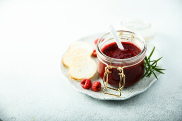 Raspberry jam or sauce with fresh rosemary