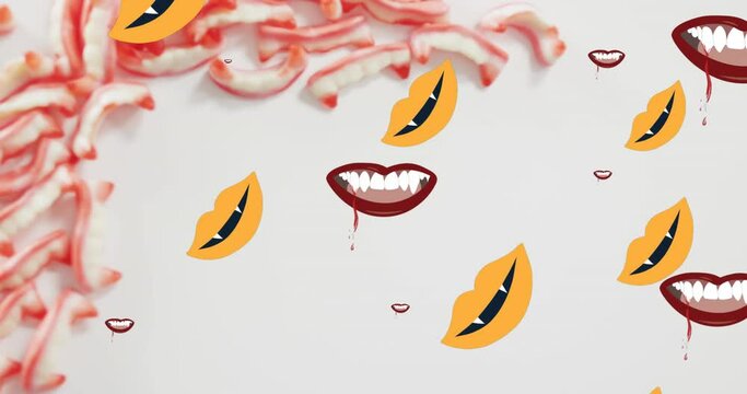 Animation of halloween vampire teeth moving over sweets on grey background