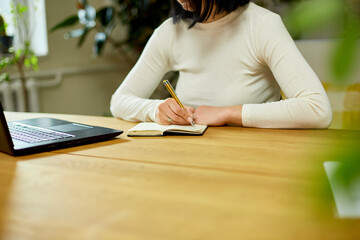 Woman hand making notes in notepad, businesswoman freelancer