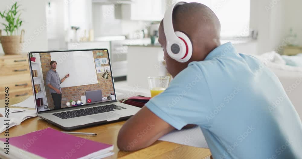 Sticker Animation of african american boy in headphones having online lessons on laptop