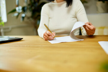 Woman hand signing a contract, making a deal with business partner.