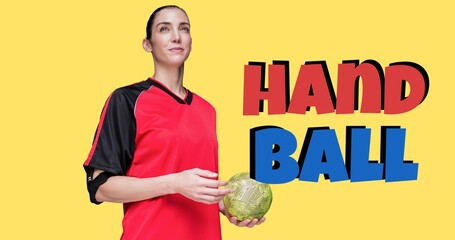Smiling female caucasian player looking away and holding ball, handball text on yellow background - Powered by Adobe