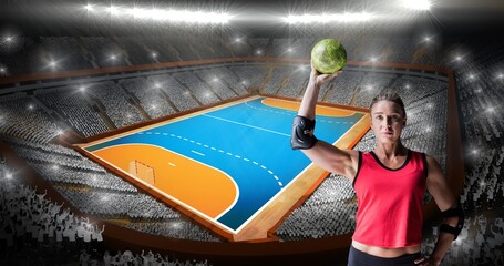 Digital portrait of muscular female caucasian handball player holding ball at illuminated stadium