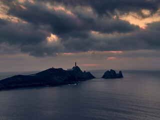 Sunset at Cape Vilan Lighthouse and Reira beach in Camariñas, Galicia, Spain. First electrical lighthouse in Spain.