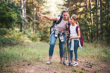 Mother and daughter enjoy hiking together.