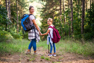 Naklejka na ściany i meble Mother and daughter enjoy hiking together.