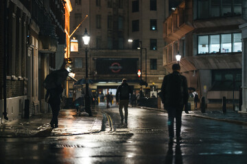 People walk to the station under the rain outside Buckingham Palace after Queen Elizabeth died