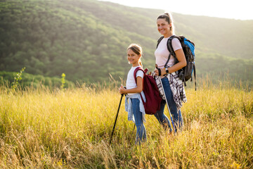 Fototapeta na wymiar Mother and daughter enjoy hiking together.