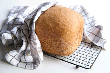 Home baked farmhouse mixed bread. Close-up on loaf of bread baked in baking machine. Whole wheat...