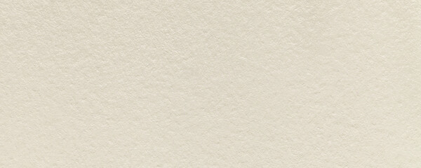 Texture of light beige and pearl colors paper background, macro. Structure of dense cream craft cardboard.