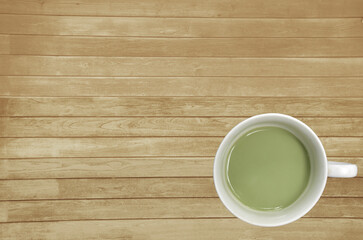 Fototapeta na wymiar Top view green tea with milk on the wooden background