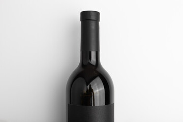 sealed red wine in a dark bottle with blank black label