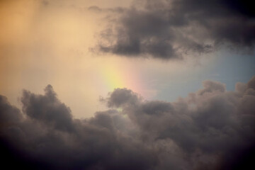 Fototapeta na wymiar Sunset sky with rainy clouds and rainbow nature background