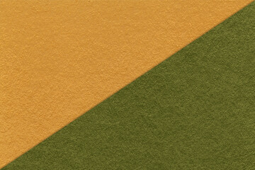 Texture of craft yellow and dark green paper background, half two colors, macro. Vintage dense kraft olive cardboard.