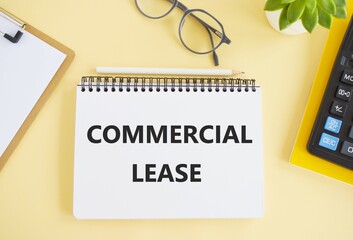 Handwriting text writing Commercial Lease. Concept meaning contract between a landlord and a business property tenants. Commercial lease text written in Notebook