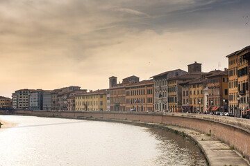 Fototapeta premium Pisa, Italy, 14 April 2022: View of the colorful banks of Arno river