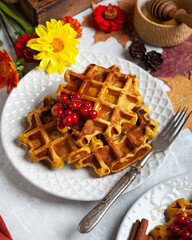 pumpkin waffles on a bright autumn table. autumn, halloween, holidays, holiday, halloween food, healthy food, organic food, farm products, autumn menu, concept.