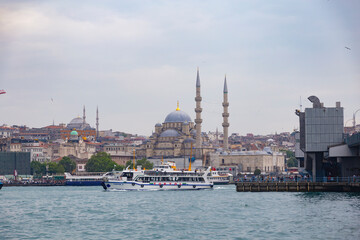 Istanbul / Turkey - 12 June 2022: Eminonu port with the Hagia Sophia museum in the background, Istanbul, Turkey