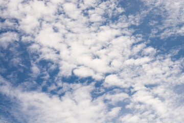 Fototapeta premium Clear blue sky background with clouds at the ocean. Copy space