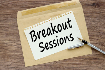 wooden background with a cover with text on a sticker. Breakout Sessions