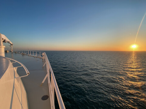 Fototapeta View from open outdoor deck of legendary luxury ocean liner cruise ship on passage during Transatlantic Crossing from Southampton to New York with deck chairs, railing and superstructure