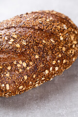 Gold rustic crusty loaves of bread and buns on wooden background. Still life captured from above top view, flat lay.