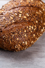 Gold rustic crusty loaves of bread and buns on wooden background. Still life captured from above top view, flat lay.