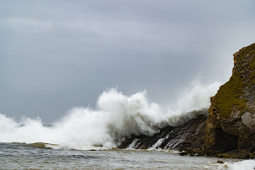 A wave crashes on the coast, Dorset, England