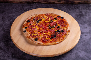 Pizza. Traditional Italian cuisine delicacies. mixed pizza on dark background