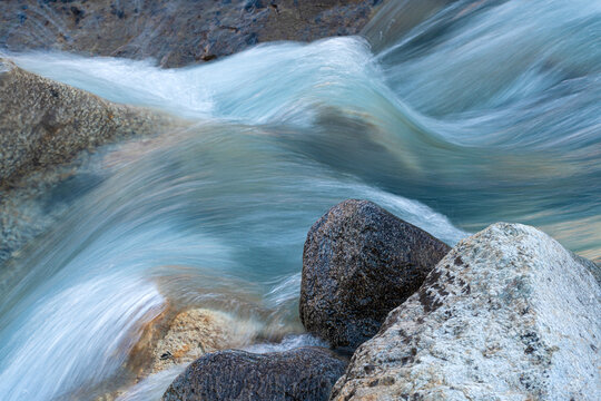 Long time exposure of the flowing water of a creek in the Swiss Alps
