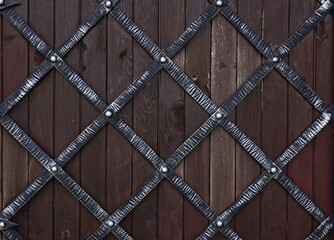 Wrought-iron gates with wooden backdrop