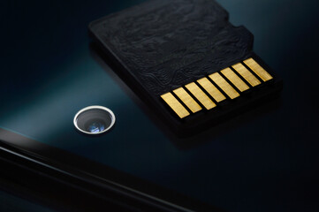 micro sd card lies on the smartphone screen. close-up