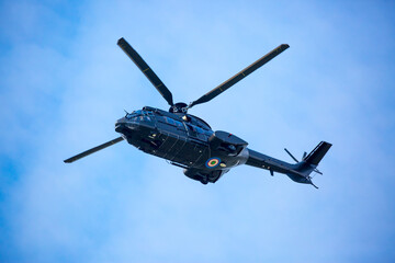 Helicopter close-up against the sky. Rescue helicopter flies in the sky with clouds.